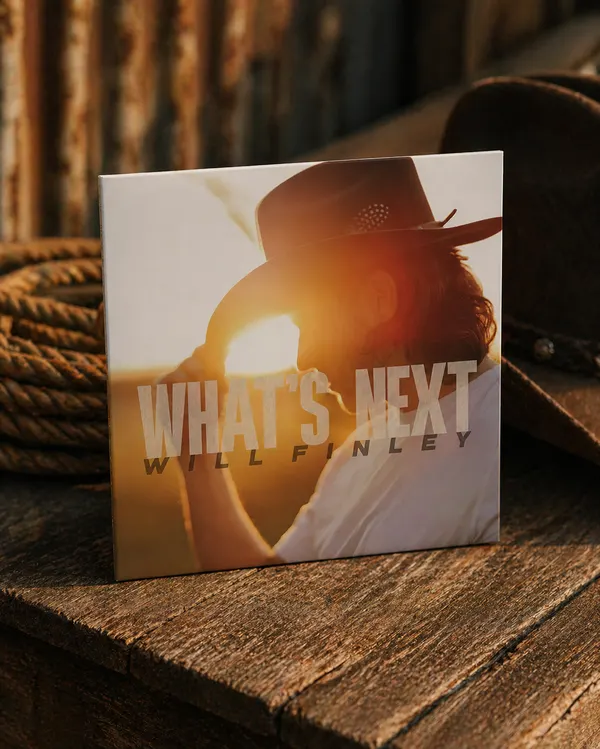 Signed Will Finley What's Next CD on a wood crate at golden hour